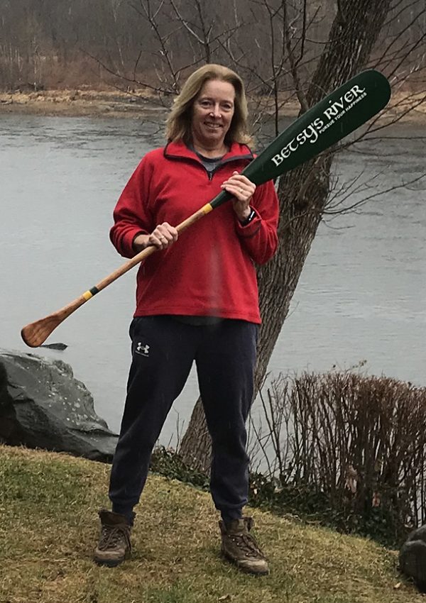 Betsy holding her hand painted paddle
